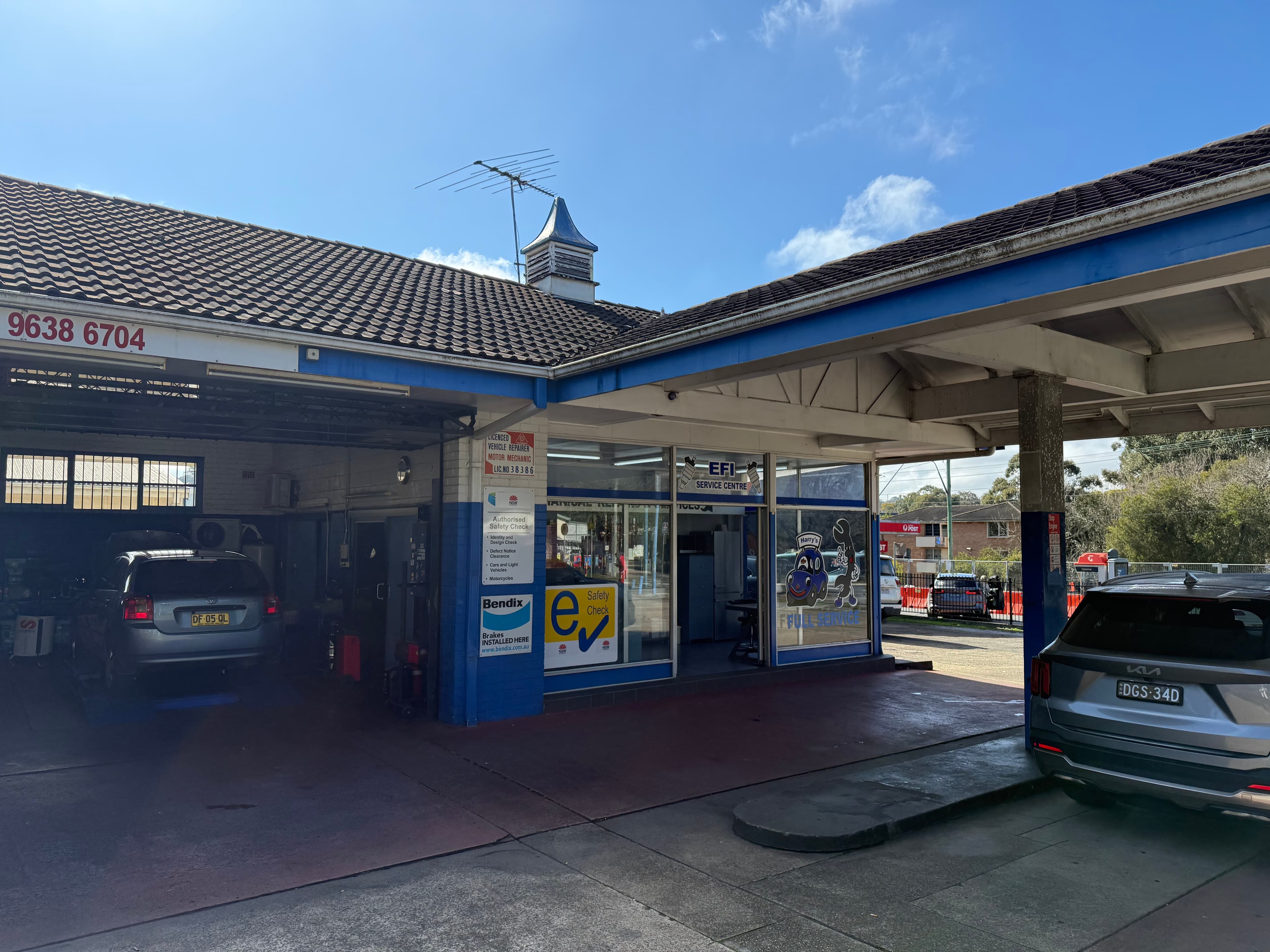 Vehicle being serviced in an open workshop bay