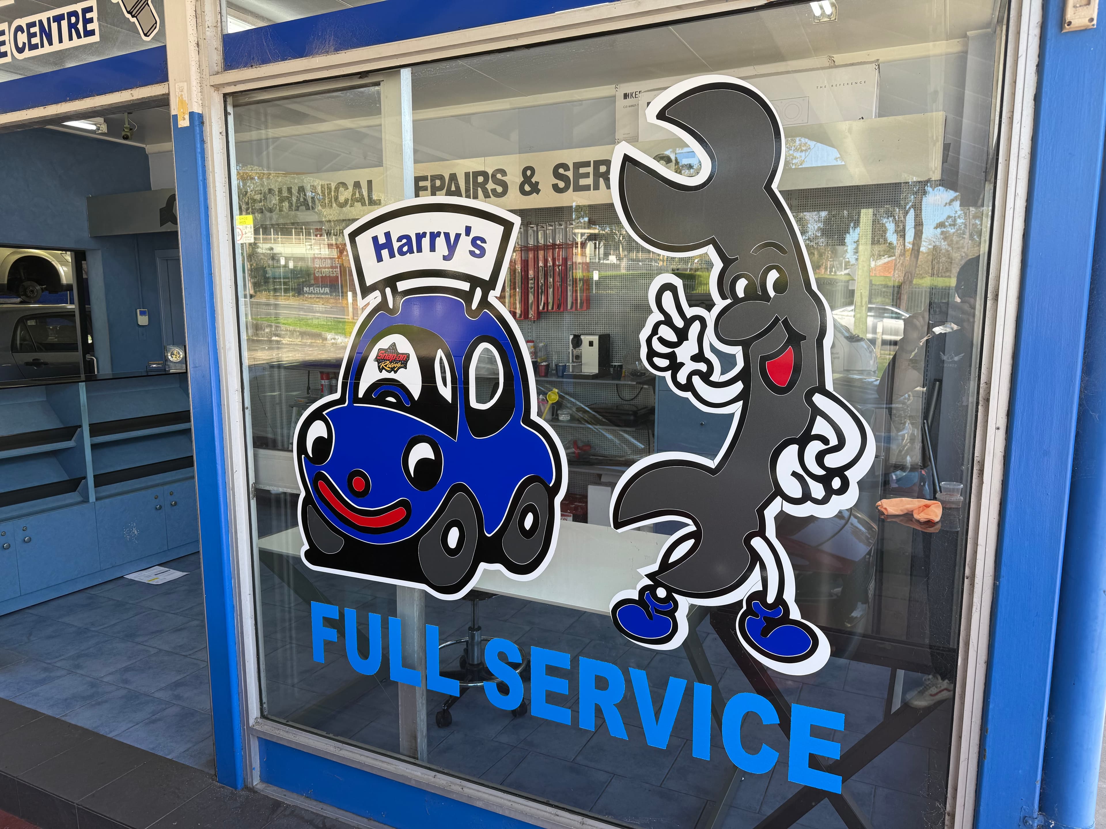 Harry's Full Service window graphics at the workshop