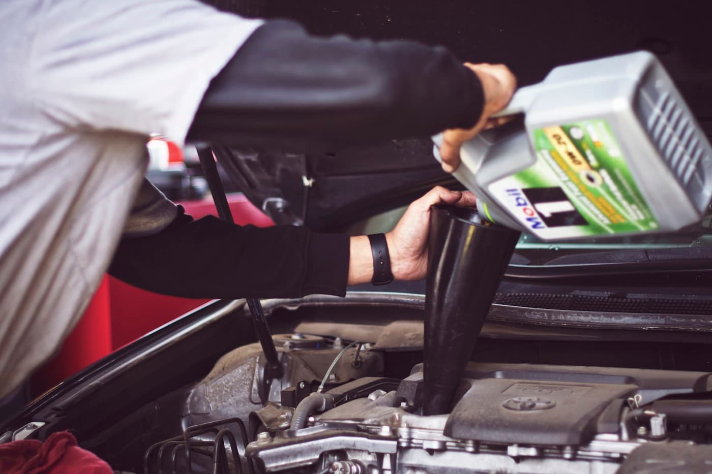 Oil being poured into an engine during a service
