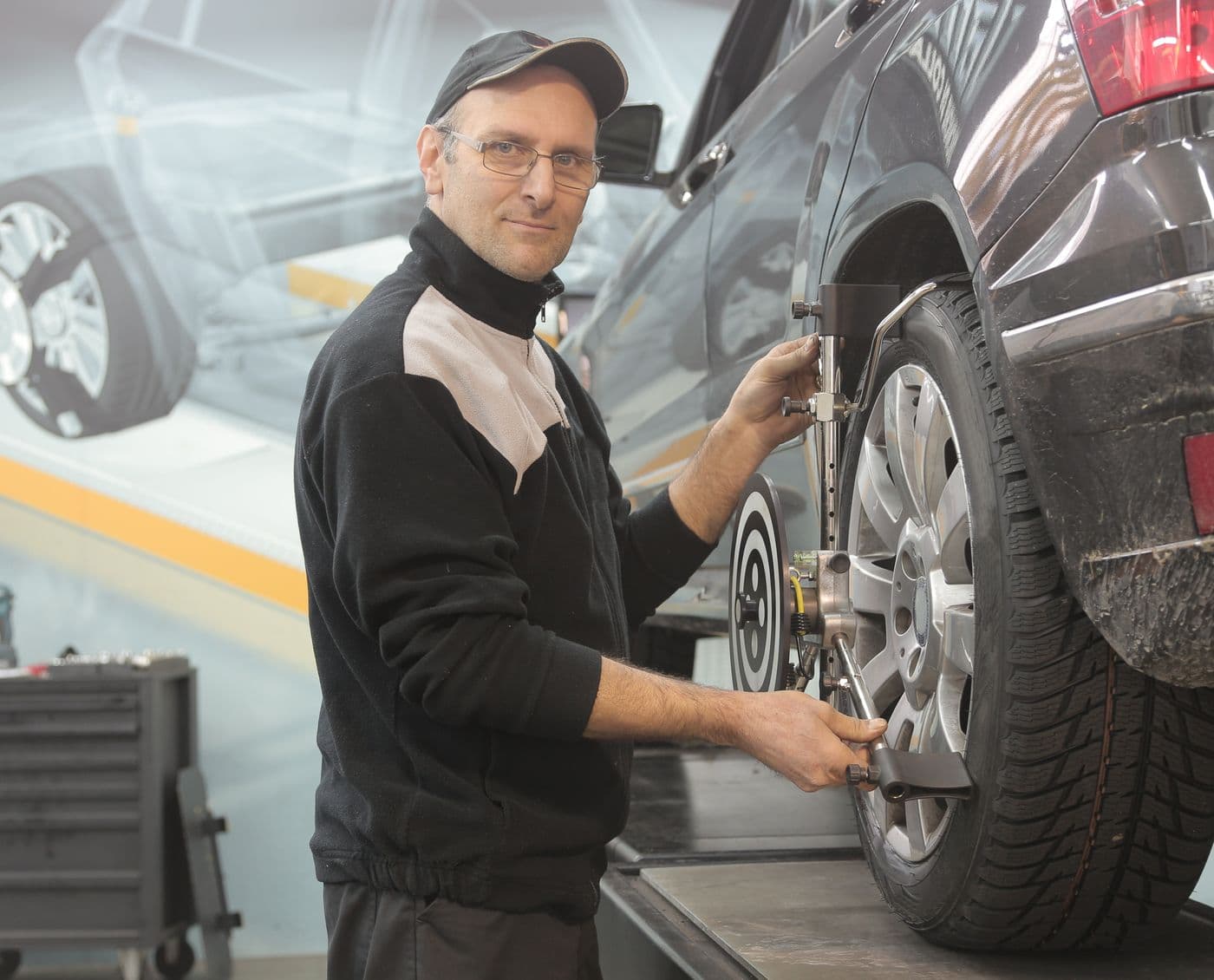 Mechanic carrying out a wheel alignment inspection